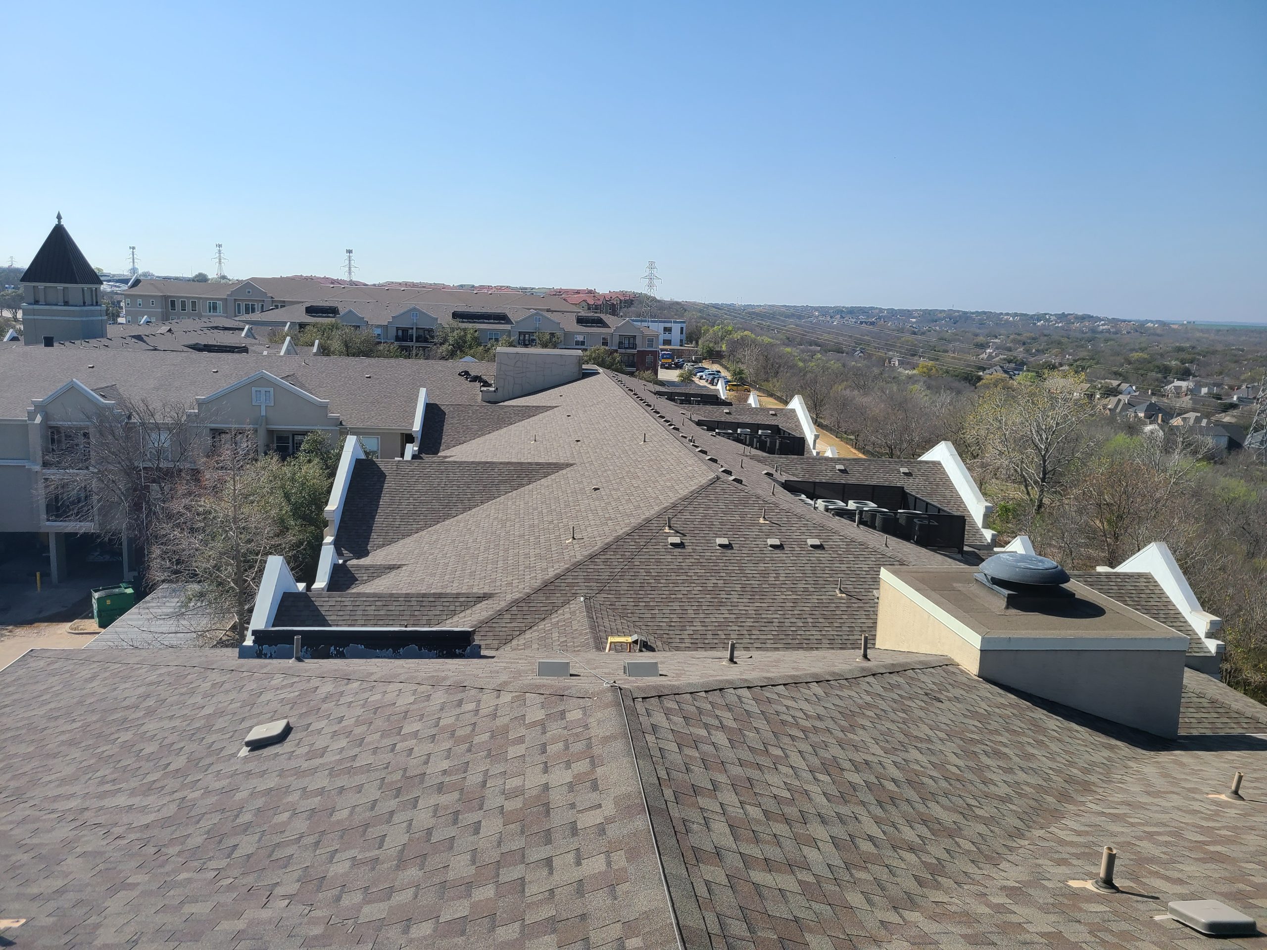 Rooftop view of residential buildings with asphalt shingles, showcasing Texcore Construction's roofing services and quality installations in Fort Worth.