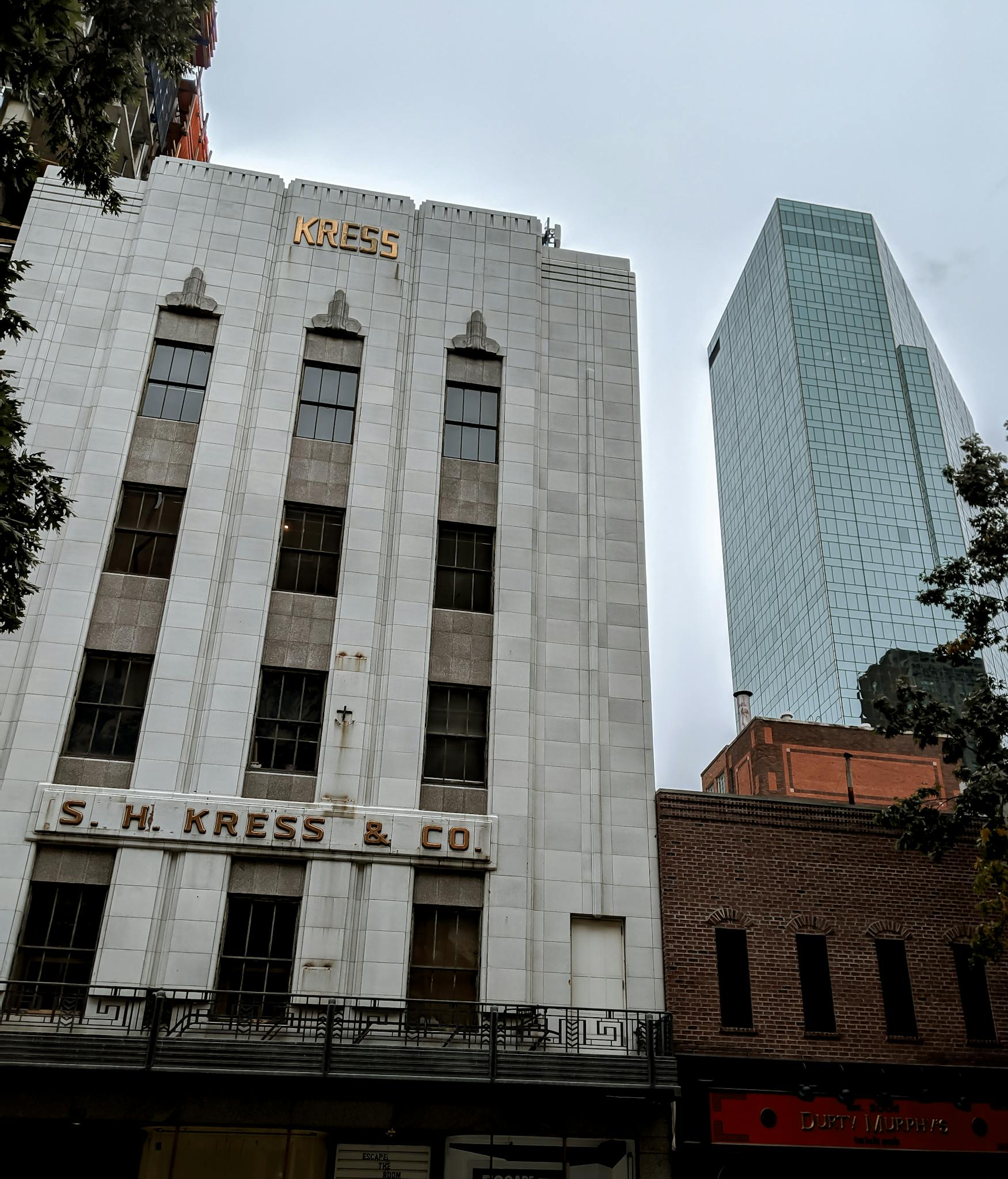 Urban landscape of downtown Fort Worth with the historic Kress building and modern skyscrapers.