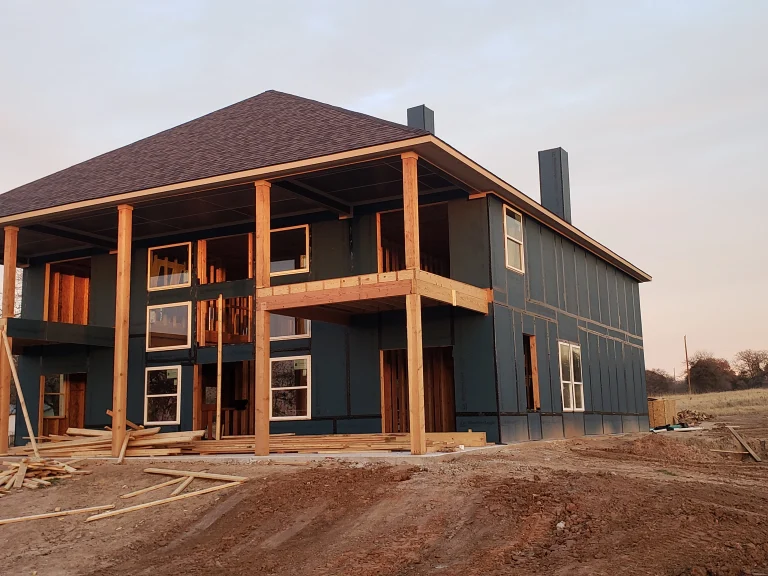 New-construction home with roofing installation in progress